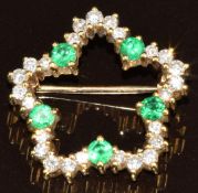 An 18ct gold brooch set with twenty-five diamonds totalling approximately 0.5ct and five round cut