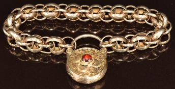 Victorian curb link bracelet made up of faceted links, the padlock clasp set with a garnet cabochon,