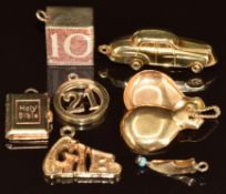 Five 9ct gold charms / pendants in the form of a car, 'GIB', '21', Holy Bible and 10 shilling