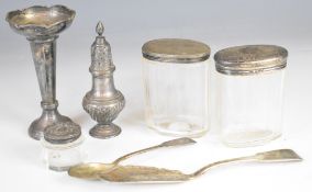 Hallmarked silver items comprising Walker and Hall pepper, fiddle pattern butter knife and teaspoon,