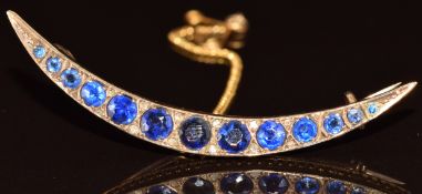 Edwardian 9ct gold crescent brooch set with graduated sapphires (largest approximately 0.22ct) and