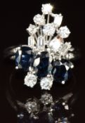 An 18ct white gold ring set with three oval cut sapphires, each approximately 0.5ct, and round and