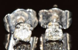 A pair of 18ct white gold earrings each set with a diamond of approximately 0.12ct, 1g