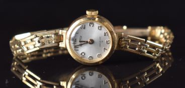 Roamer 9ct gold ladies wristwatch with gold hands and Arabic numerals, silver dial and signed 19