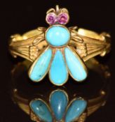 A yellow metal ring in the form of a fly set with turquoise cabochons and ruby eyes, 3.8g, size J
