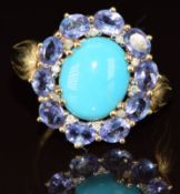 A 9ct gold ring set with turquoise surrounded by tanzanites and diamonds, 3.6g, size Q