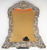Victorian or Edward VII hallmarked silver dressing table mirror with embossed foliate and floral