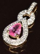 A 9ct gold pendant set with a pear cut pink sapphire of approximately 0.6ct surrounded by diamonds,