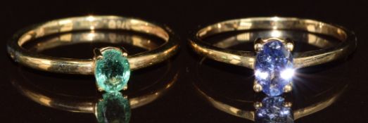 Two 9ct gold rings, one set with an oval cut emerald and the other an oval cut tanzanite, 2.7g, size