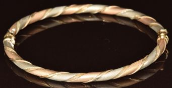 A 9ct gold tri-coloured bangle with textured finish, 6g, 6.5 x 5.4cm