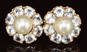 A pair of 9ct rose gold earrings each set with a pearl of approximately 7.5mm surround by eight