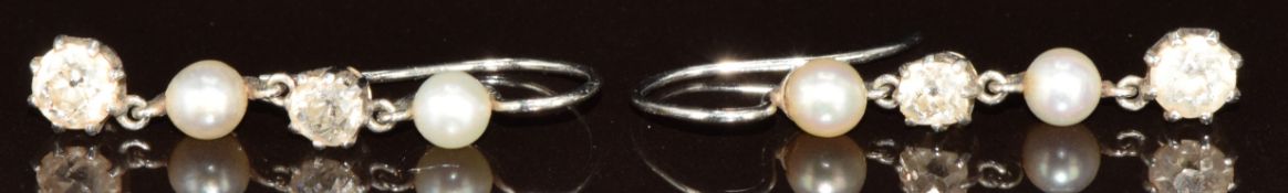 A pair of c1900 white metal earrings each set with two old cut diamonds of approximately 0.15 & 0.