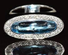 An 18k white gold ring set with a blue topaz cabachon surrounded by diamonds, 7.1g, size N