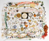 A collection of jewellery including carved jadeite pendant, necklaces including coral, aventurine