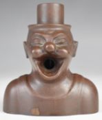Gibus of Denmark Gutta Percha or bakelite figural mechanical cigar cutter with spring loaded top