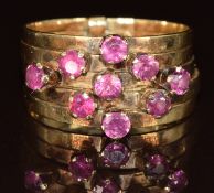 A 14k gold ring set with nine round cut rubies on five bands, 5g, size Q