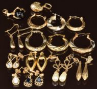 Seven pairs of 9ct gold earrings including hoops, sapphire, etc, five single earrings and two 9ct