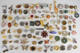 A collection of vintage brooches including silver gilt cameo, diamanté, enamel and marcasite,