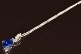 A 9k white gold pendant set with a pear cut synthetic sapphire of approximately 0.4ct and two