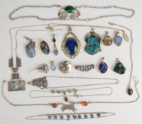 A collection of silver jewellery including six pendants and a necklace all set with opal doublets,