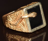 An 18ct gold signet ring set with onyx, with engraved decoration to the shoulder and serpent