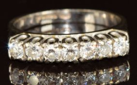 An 18ct white gold ring set with seven round cut diamonds, each approximately 0.1ct, 3.5g, size L