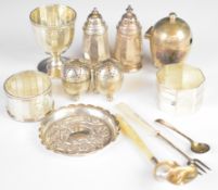 Hallmarked silver items to include napkin rings, egg cup, egg shaped mustard with blue glass
