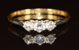 An 18ct gold ring set with three diamonds in a platinum setting, 1.6g, size M