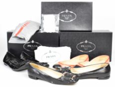 Three pairs of Prada shoes including black pumps with silver buckle, size 39, peach, pink and