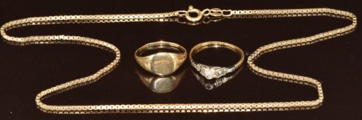 An 18ct gold ring set with a diamond in a platinum setting (1.5g, size O) and a yellow metal