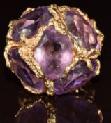 A 14k gold ring set with five oval cut amethyst in a textured abstract pierced setting, 20g, size N