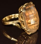 An 18k gold ring set with a smoky quartz in a foliate setting, 11.4g, size M