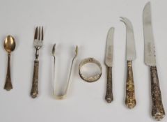 Hallmarked silver sugar tongs, hallmarked silver napkin ring, hallmarked silver handled bread (