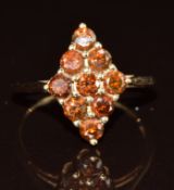 A 9ct gold ring set with brown diamonds in a marquise shaped setting, 2.2g, size N/O