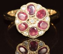 A 9ct gold ring set with six oval cut garnets and diamonds in a flower cluster, 3.5, size N