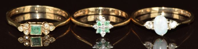 Three 9ct gold rings, two set with emeralds and diamonds, and the other an opal and two diamonds,