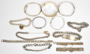 A collection of silver bracelets including two Christening bangles, 835 bracelet, two gate
