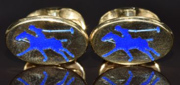 A pair of silver gilt cufflinks set with blue enamel depicting a polo player, 14.7g