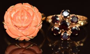 An 18k gold ring set with garnets and a yellow metal ring set with a carved coral flower, 9.3g, size