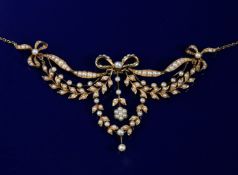 Edwardian 15ct gold necklace set with seed pearls in a bow and foliate design, with barrel clasp,