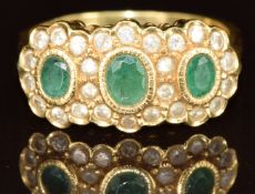 An 18ct gold ring set with emeralds and diamonds, total diamond weight 0.5ct, 5.5g, size O