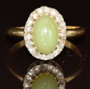 An 18ct gold ring set with a hardstone cabochon surrounded by rose cut diamonds, 2.4g, size K