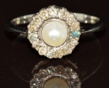 A c1900 platinum ring set with a natural pearl (4.6mm) surrounded by old cut diamonds, 2.7g, size N