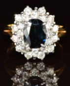 An 18ct gold ring set with an oval cut sapphire of approximately 1.5ct surrounded by twenty-four