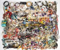A collection of jewellery including vintage brooches, beaded necklaces, bangles, Swarovski