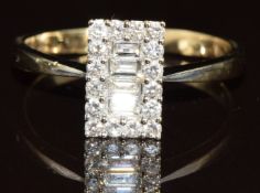 An 18ct white gold ring set with four baguette cut diamonds, each approximately 0.05ct, surrounded