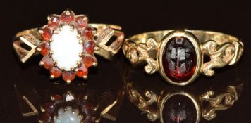 Two 9ct gold rings, one set with an opal surrounded by garnets and the other a garnet cabochon, 3.