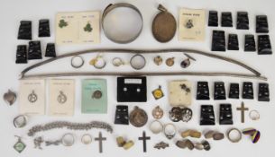 A collection of silver jewellery including bangle with scrolling decoration, two coiled necklaces (