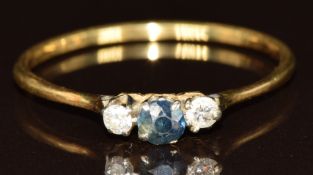 An 18ct gold ring set with a round cut sapphire and two diamonds, 2.4g, size Z + 2