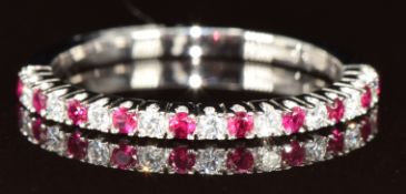 An 18ct white gold half eternity ring set with alternating rubies and diamonds, 2g, size M